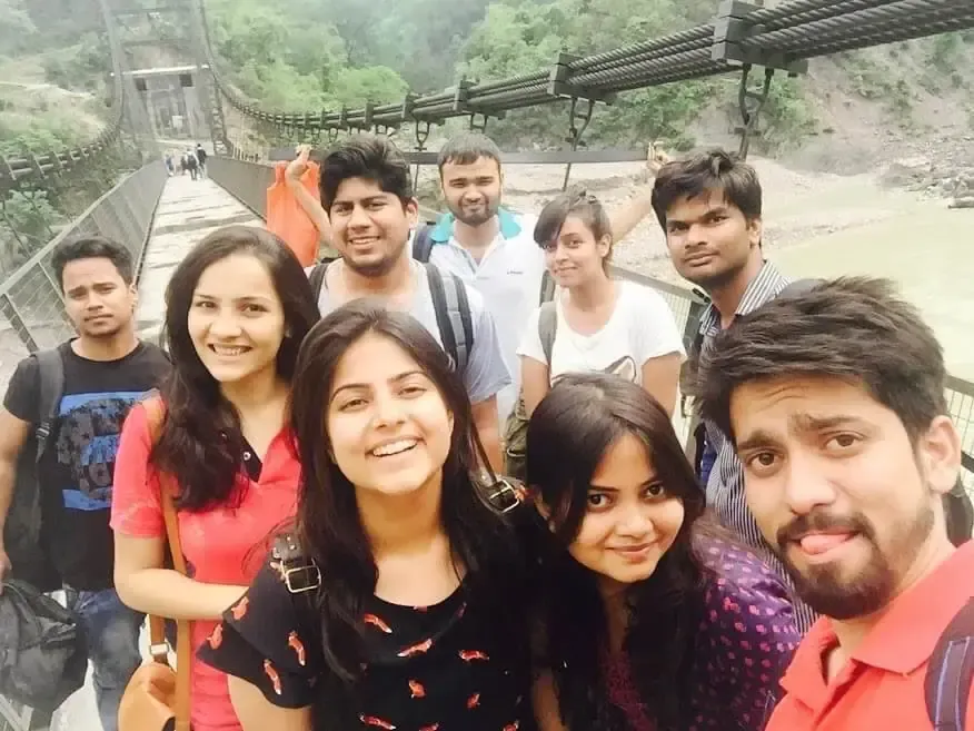 Supplymint team selfie on a suspension bridge over a river during a team trip in the hills