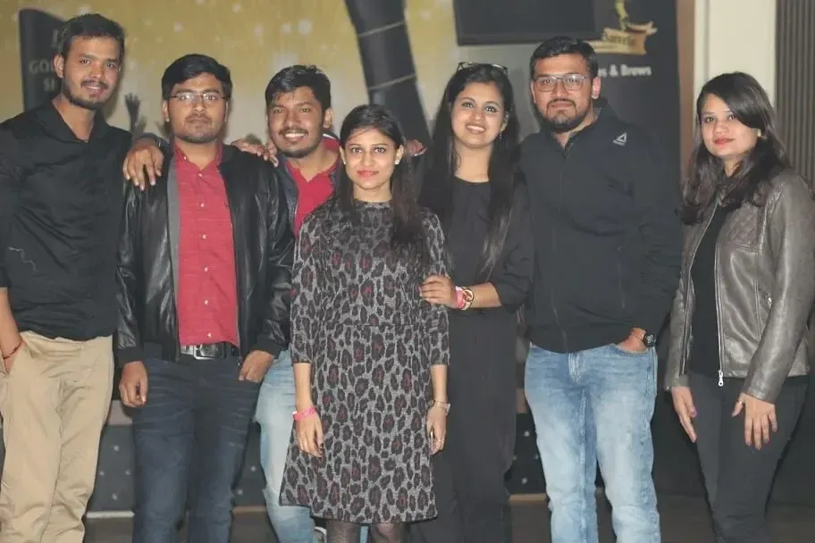 Seven Supplymint colleagues posing together at an evening team event