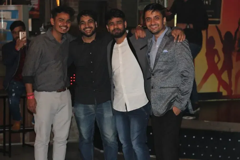 Four Supplymint team members smiling together at a team party