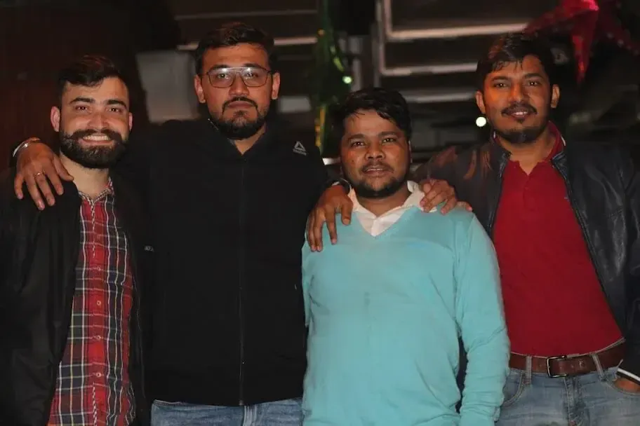 four Supplymint colleagues posing arm in arm at an evening team outing