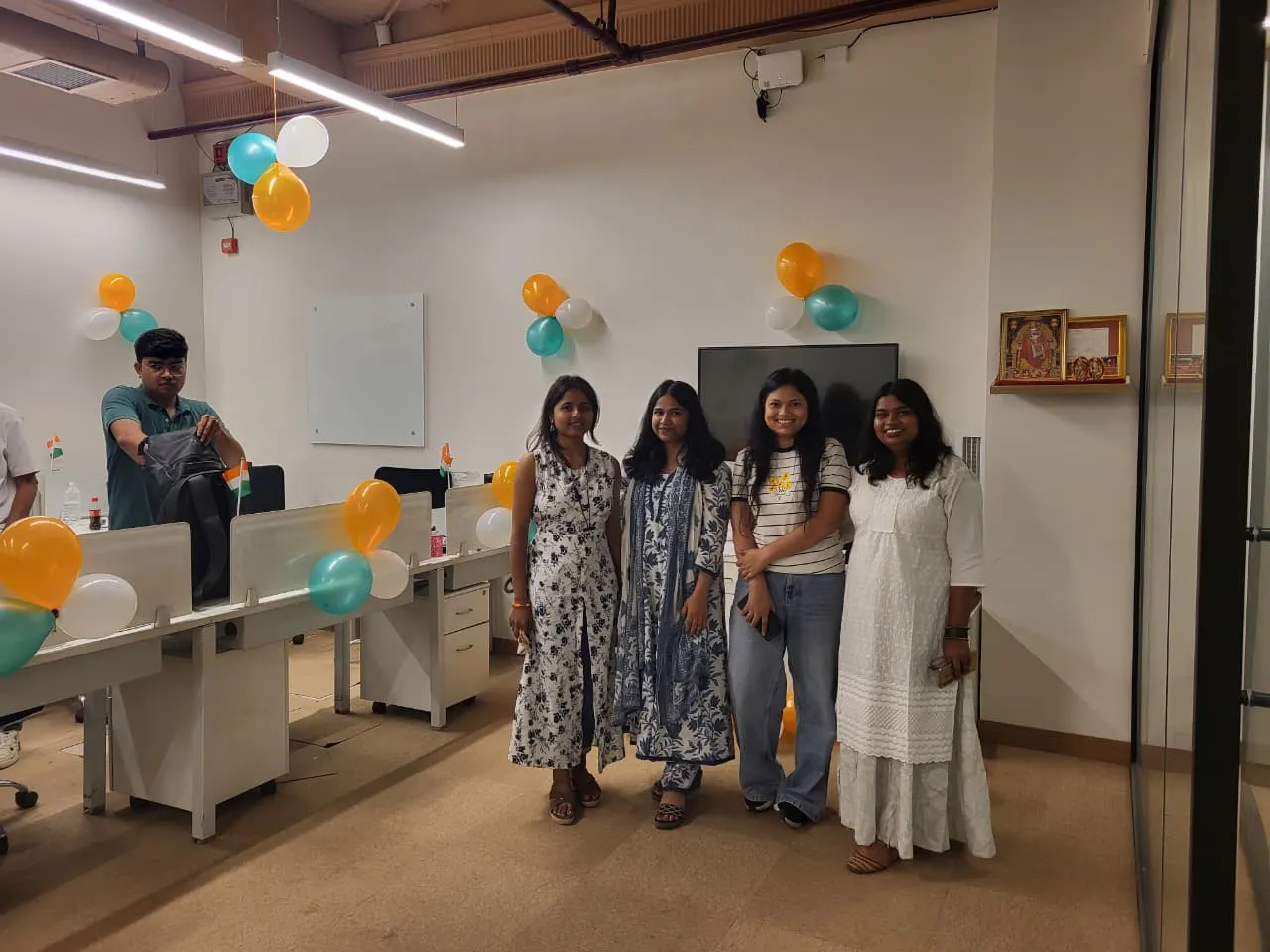 Supplymint team members posing together in the office decorated with tricolour balloons for Independence Day